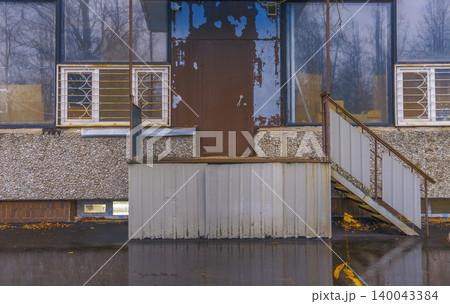 Abandoned rusty platform. Longneglected concrete space with corroded fixtures and dull sky reflection 140043384
