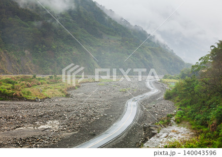 Temporary Riverbed Road Through Flood Damaged Valley 140043596