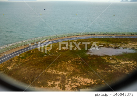 Looking from the airplane window of the landing scene. The scene of the airport apron. Travel and transportation concept. 140045375