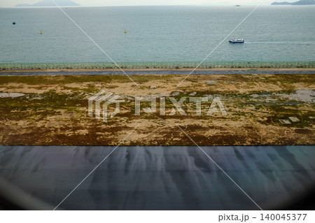 Looking from the airplane window of the landing scene. The scene of the airport apron. Travel and transportation concept. 140045377