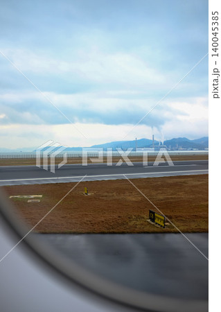 Looking from the airplane window of the landing scene. The scene of the airport apron. Travel and transportation concept. Looking from the airplane window of the landing scene. The scene of the airport apron. Travel and transportation concept. 140045385