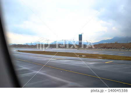 Looking from the airplane window of the landing scene. The scene of the airport apron. Travel and transportation concept. Looking from the airplane window of the landing scene. The scene of the airport apron. Travel and transportation concept. 140045386