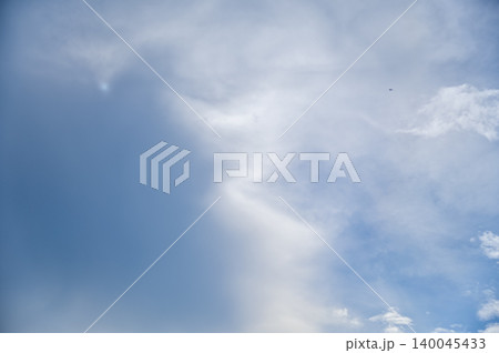 Cloudscape with clouds covering the sun under the blue sky. Nature scene, skyscape and cloudscape. 140045433