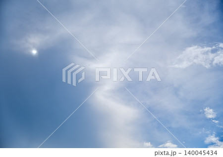 Cloudscape with clouds covering the sun under the blue sky. Nature scene, skyscape and cloudscape. Cloudscape with clouds covering the sun under the blue sky. Nature scene, skyscape and cloudscape. 140045434