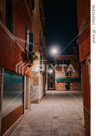 Empty Venice street at night with soft lights and historic architecture Empty Venice street at night with soft lights and historic architecture 140045940