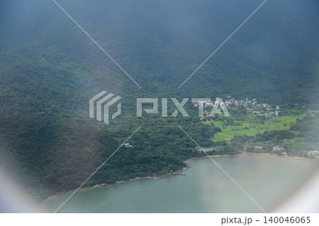 Looking through airplane window with the view of Hong Kong scene. Hong Kong rural area, Hong Kong Mountains from the high angle view. Nature scene. Looking through airplane window with the view of Hong Kong scene. Hong Kong rural area, Hong Kong Mountains from the high angle view. Nature scene. 140046065