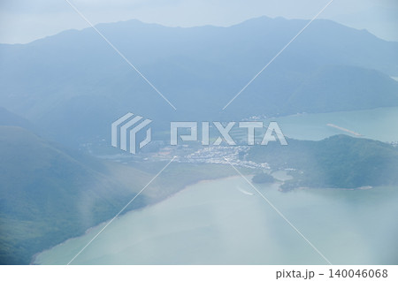 Looking through airplane window with the view of Hong Kong scene. Hong Kong rural area, Hong Kong Mountains from the high angle view. Nature scene. Looking through airplane window with the view of Hong Kong scene. Hong Kong rural area, Hong Kong Mountains from the high angle view. Nature scene. 140046068