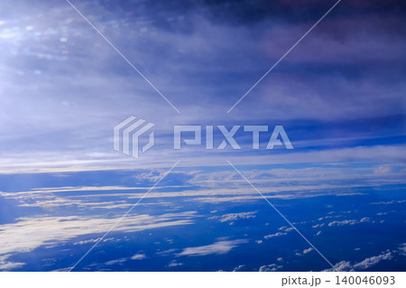Looking through airplane window with dramatic cloudscape. white clouds with the blue sky from the high angle view. Cloudscape background. Nature scene. 140046093