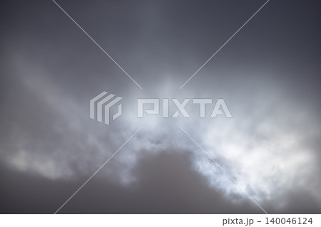 Cloudscape with gray clouds under the sky, strong sunbeam through the gray clouds. Overcast scene. Nature scene. Cloudscape with gray clouds under the sky, strong sunbeam through the gray clouds. Overcast scene. Nature scene. 140046124