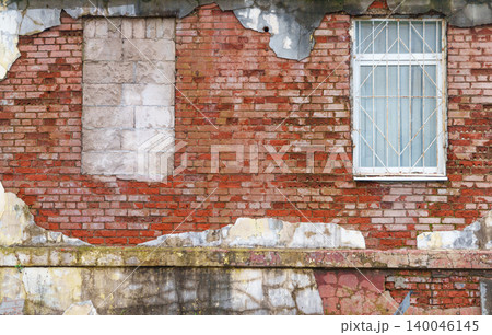 Weathered wall with cracks. Distressed brick structure with stains and chipped surface detailing Weathered wall with cracks. Distressed brick structure with stains and chipped surface detailing 140046145