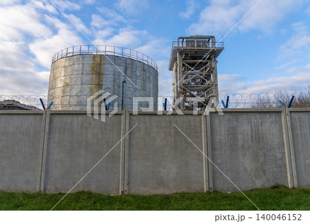 Industrial structure with safety features. Industrial environment including tanks and safety pathways Industrial structure with safety features. Industrial environment including tanks and safety pathways 140046152