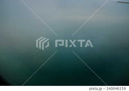 Looking through airplane window with the view of ocean of Hong Kong water. Ships sailing on the sea. Nature scene. Looking through airplane window with the view of ocean of Hong Kong water. Ships sailing on the sea. Nature scene. 140046159