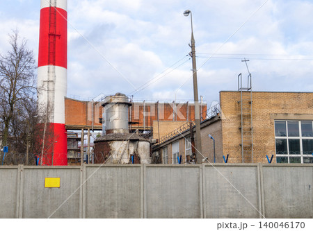 Detailed view of industrial piping and masonry. Close proximity shot of plant piping and wall surfaces 140046170