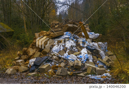 Unkempt rubbish scattered outdoors. Discarded waste and pollution create contaminated woodland scene Unkempt rubbish scattered outdoors. Discarded waste and pollution create contaminated woodland scene 140046200