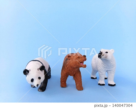 Panda and bear (ursidae) toys on a blue background. Panda and bear (ursidae) toys on a blue background. 140047304