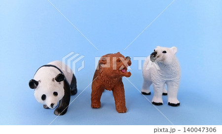 Panda and bear (ursidae) toys on a blue background. Panda and bear (ursidae) toys on a blue background. 140047306