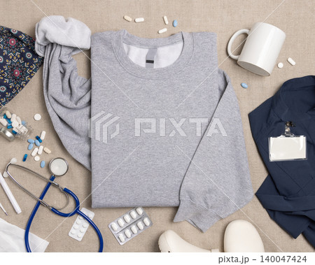 Blank grey unisex sweatshirt mockup with medical accessories top view, print on demand template 140047424