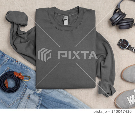 Blank grey unisex sweatshirt mockup, folded crewneck with denim jeans and mens accessories Blank grey unisex sweatshirt mockup, folded crewneck with denim jeans and mens accessories 140047430