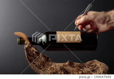 Bottle of red wine with empty label. Bottle of red wine with empty label. 140047689