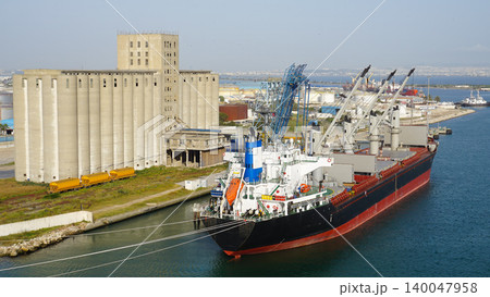 La Goulette, Tunisia - Seaport with a cargo ship moored next to a grain elevator in the port of La Goulette, Tunisia 140047958