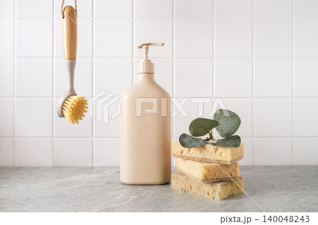 Eco cleaning products and reusable sponges in kitchen interior Eco cleaning products and reusable sponges in kitchen interior 140048243