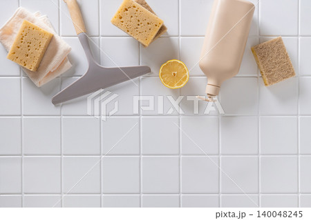 Eco friendly cleaning supplies on white tile background with copy space Eco friendly cleaning supplies on white tile background with copy space 140048245