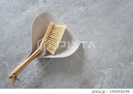 Dustpan and brush on stone background with copy space 140048246