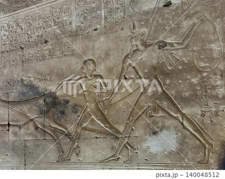 Beautiful bas-reliefs and ancient hieroglyphs in the Temple of Seti I in Abydos, Egypt. 140048512