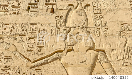 Beautiful bas-reliefs and ancient hieroglyphs from the mortuary temple of Ramesses III at Medinet Habu, Luxor, Egypt. 140048533