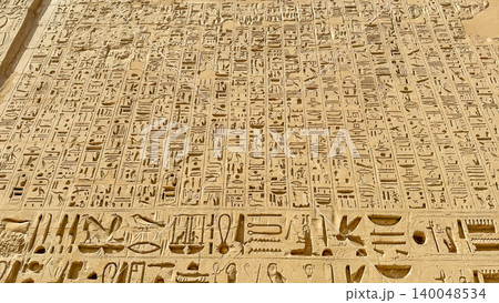 Beautiful bas-reliefs and ancient hieroglyphs from the mortuary temple of Ramesses III at Medinet Habu, Luxor, Egypt. 140048534