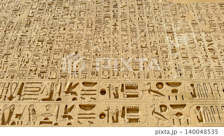 Beautiful bas-reliefs and ancient hieroglyphs from the mortuary temple of Ramesses III at Medinet Habu, Luxor, Egypt. 140048535