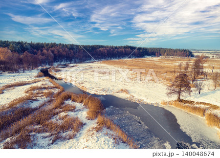 Aerial view of winter snowy countryside.  Frozen river on snowy field 140048674