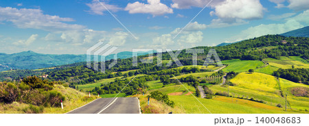 Road among grassed fields. Tuscany landscape. Picturesque countryside Road among grassed fields. Tuscany landscape. Picturesque countryside 140048683