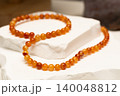 Cracked agate jewelry displayed on a white stone surface 140048812