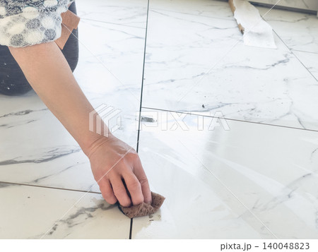 Cleaning grout lines on tiles Cleaning grout lines on tiles 140048823