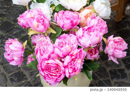 Pot with a lot of pink peony flowers. Outside decor, plants in the garden near the house. Pot with a lot of pink peony flowers. Outside decor, plants in the garden near the house. 140048930