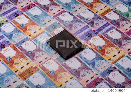 Qatar, Qatari riyal, paper money and coins, financing and commodity exchange, trade. Qatari currency Qatar, Qatari riyal, paper money and coins, financing and commodity exchange, trade. Qatari currency 140049044