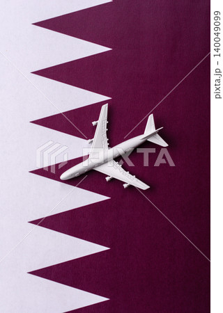 An airplane on the Qatari flag as a conceptual backdrop for flights . An airplane on the Qatari flag An airplane on the Qatari flag as a conceptual backdrop for flights . An airplane on the Qatari flag 140049099