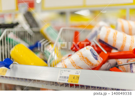 Painting rollers and DIY renovation accessories arranged on retail shelf in hardware shop Painting rollers and DIY renovation accessories arranged on retail shelf in hardware shop 140049338