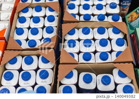 Milk cartons packed in cardboard boxes for supermarket retail distribution 140049382