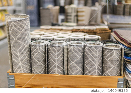 Rolled decorative rugs and floor mats displayed on shelves in home improvement store Rolled decorative rugs and floor mats displayed on shelves in home improvement store 140049386