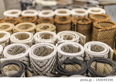Rolled decorative rugs and woven floor mats displayed in home improvement store Rolled decorative rugs and woven floor mats displayed in home improvement store 140049390