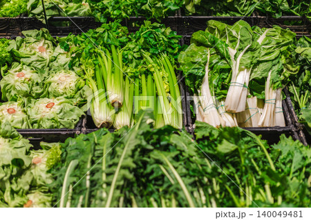 Fresh green vegetables arranged on supermarket shelves in grocery produce section Fresh green vegetables arranged on supermarket shelves in grocery produce section 140049481
