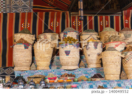 Traditional spices and herbs displayed in woven baskets at Egyptian market stall Traditional spices and herbs displayed in woven baskets at Egyptian market stall 140049552