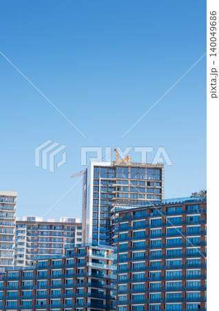 High-rise building under construction with tower crane, urban development and real estate concept 140049686