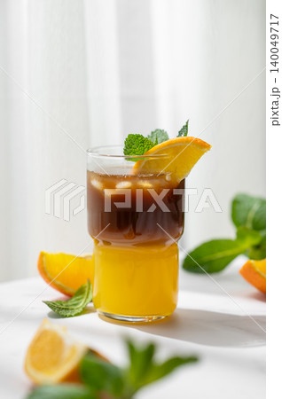 Cold bumble coffee with orange juice and ice on marble background Cold bumble coffee with orange juice and ice on marble background 140049717