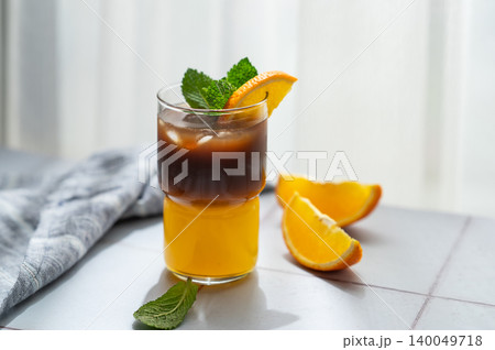 Cold bumble coffee with orange juice and ice on light background 140049718
