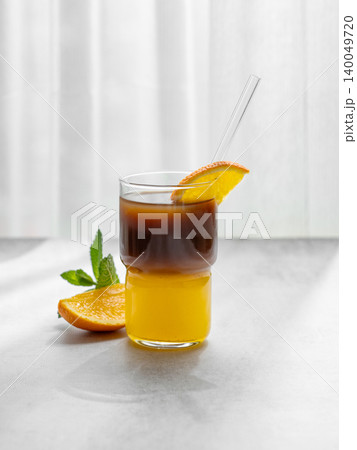 Cold bumble coffee with orange juice and ice on light background 140049720