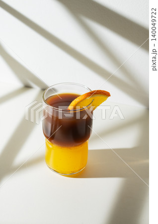 Cold bumble coffee with orange juice and ice on light background Cold bumble coffee with orange juice and ice on light background 140049722