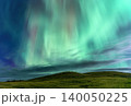Vibrant green aurora borealis dances across a starry night sky over hills 140050225